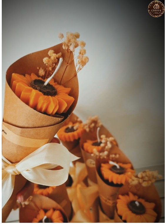 Sunflower candle bouquets wrapped in kraft cones with ribbon