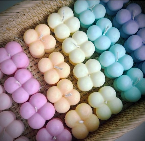Pastel bubble cube candles in a woven basket