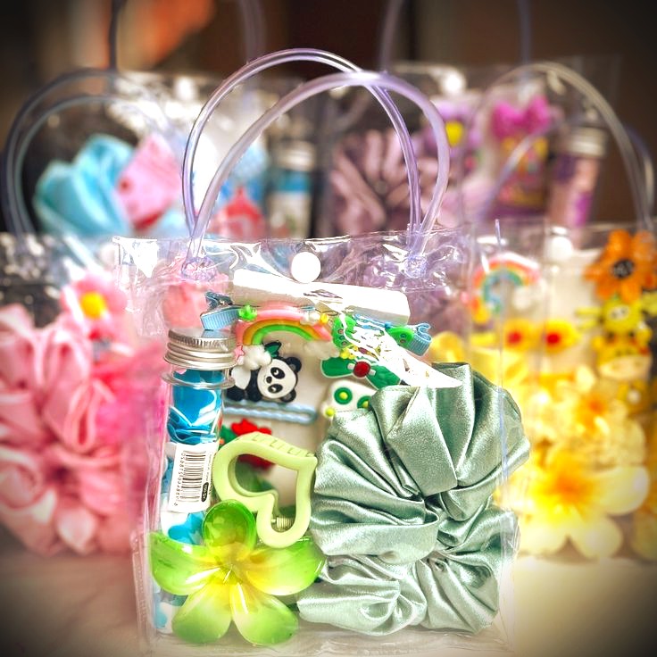 Clear tote party favours with scrunchies, toys and rainbow charms